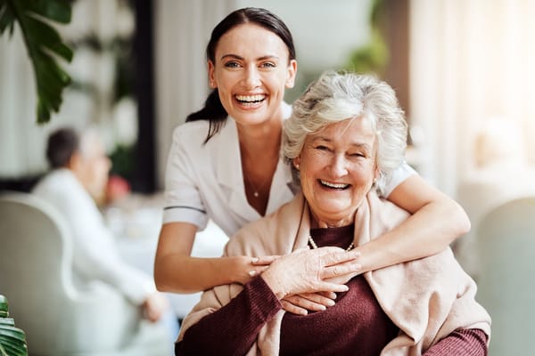 A staff member embracing a resident in a common area