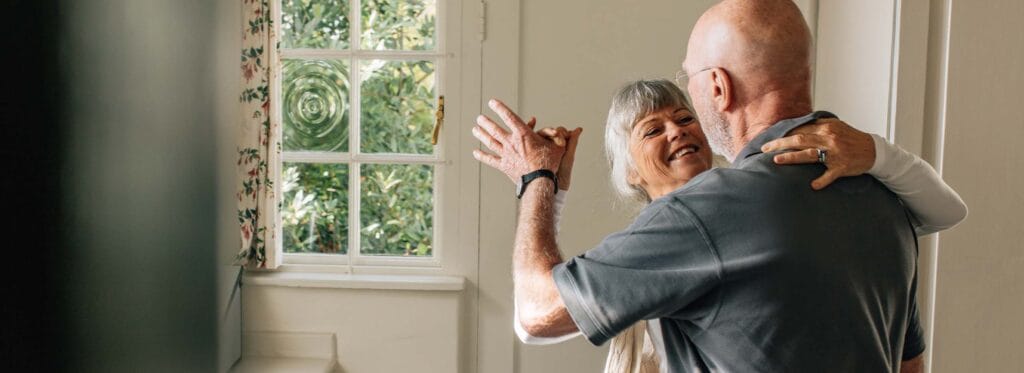 Couple dancing in a warm indoor setting