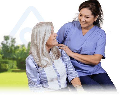 Caregiver smiling with resident in a sunny outdoor setting