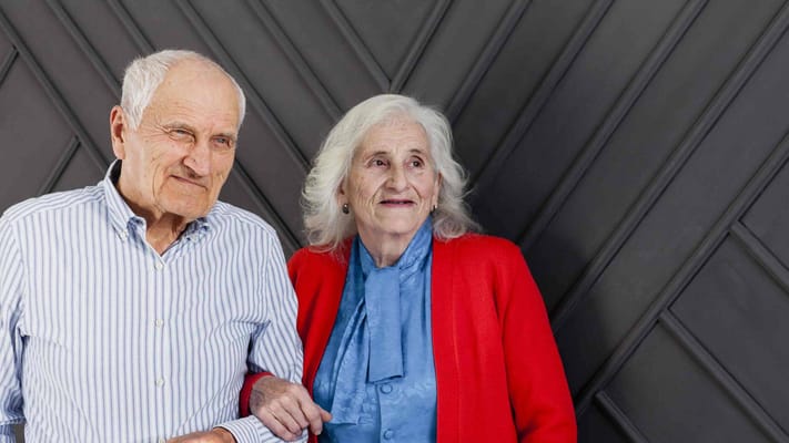 Elderly couple smiling together indoors
