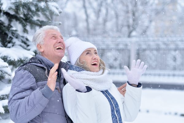 Senior couple enjoying a snowy outdoor scene
