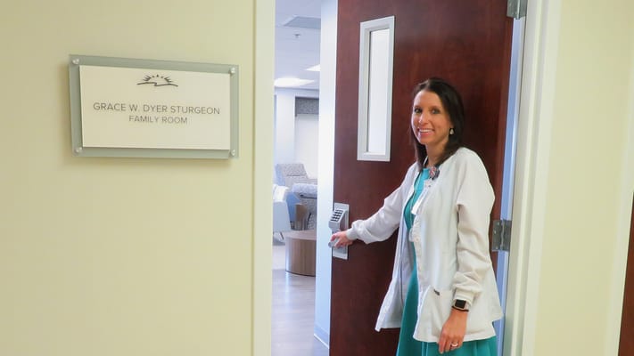 Staff member in front of the family room door