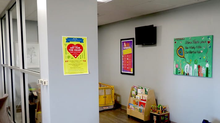 Interior hallway with activity posters and children's toys