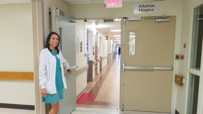 Staff member at the entrance of Arkansas Hospice