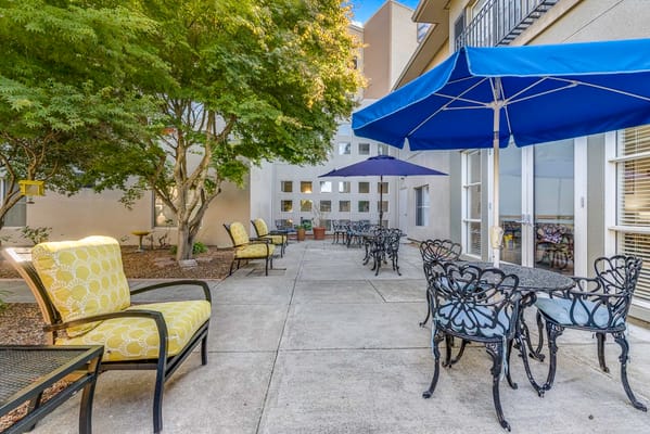 Outdoor seating area with tables and umbrellas