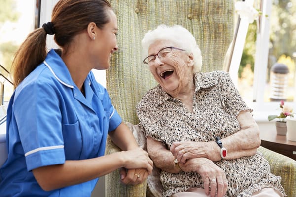 Caregiver and resident enjoying a joyful moment together
