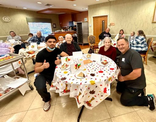 Residents and staff enjoying a meal in a dining area