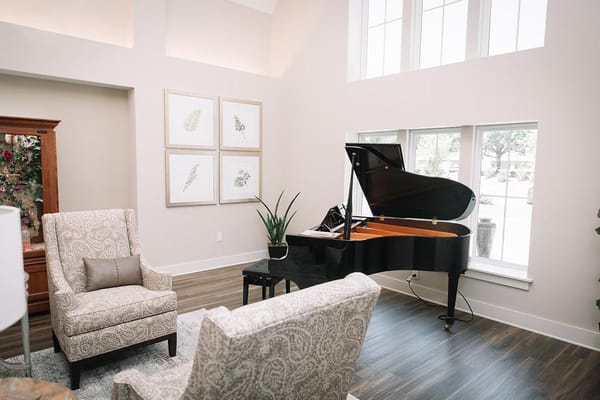 Interior lounge area with a grand piano and seating
