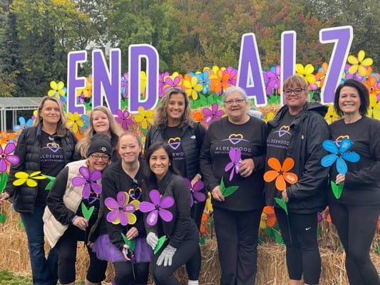 Staff and residents participating in an outdoor Alzheimer's awareness event