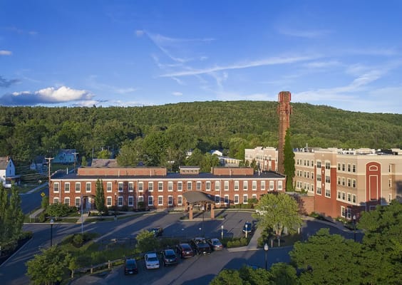 Aerial view of the American House Keene facility with surrounding greenery