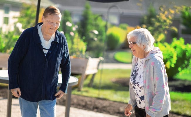 Two residents enjoying time outside in the garden