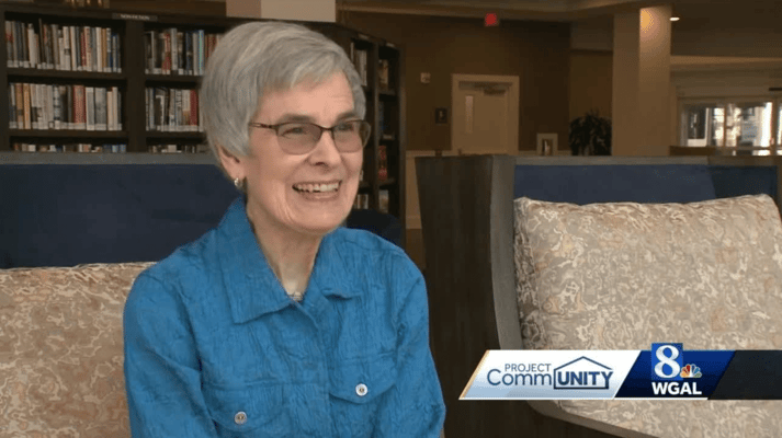 Resident smiling in a cozy common area