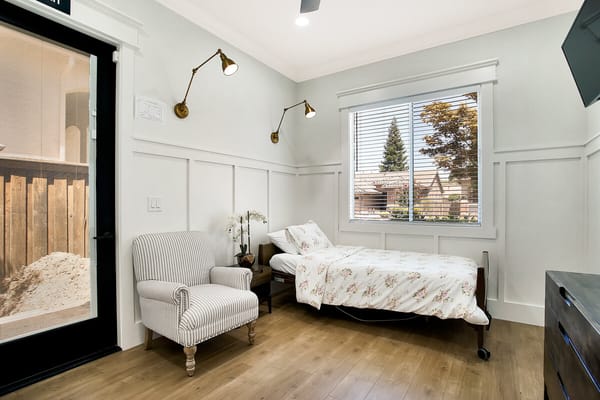 Cozy resident room with a bed and chair