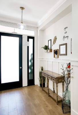 Bright entryway with wooden furniture and decor