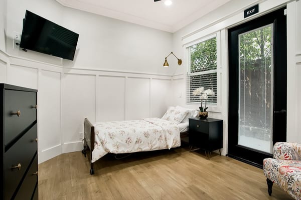 Cozy interior of a resident room with a bed and furniture