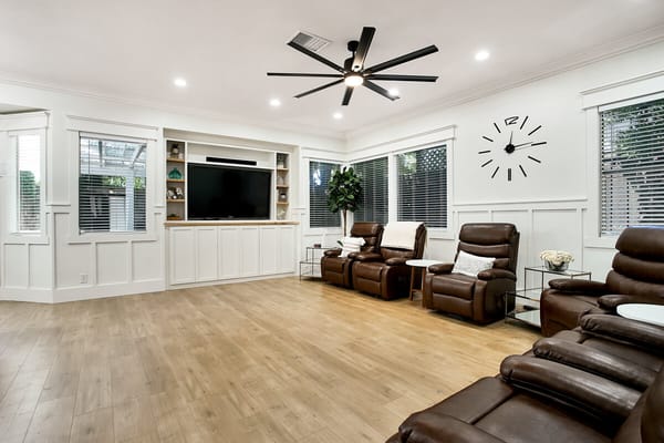 Bright common area with comfortable seating and entertainment system