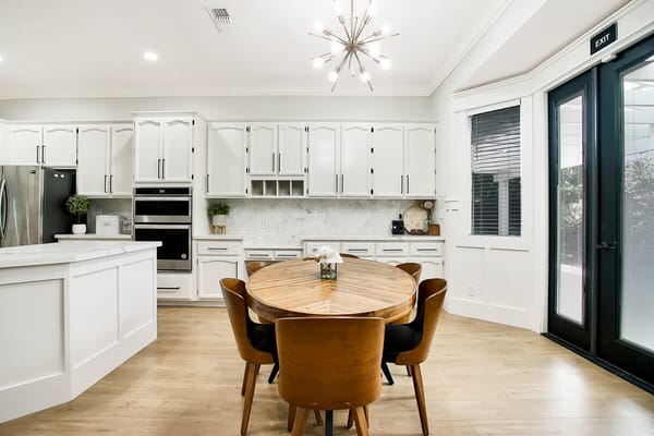 Bright, modern kitchen with a round wooden table