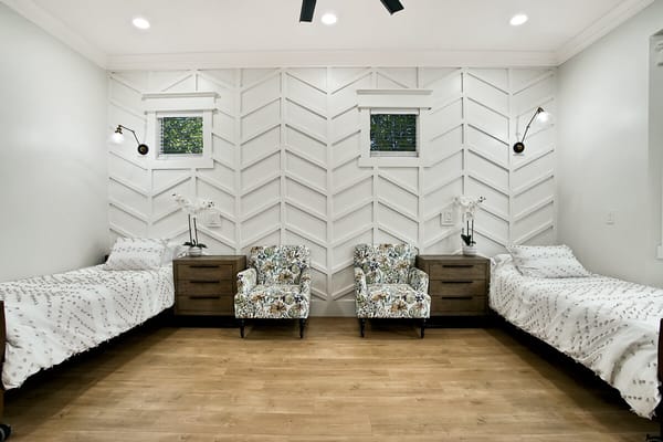 Comfortable resident room with two beds and seating area