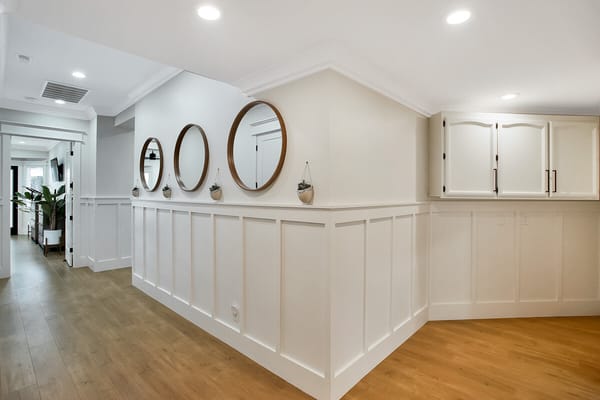 Interior hallway with mirrors and decorative wall panels
