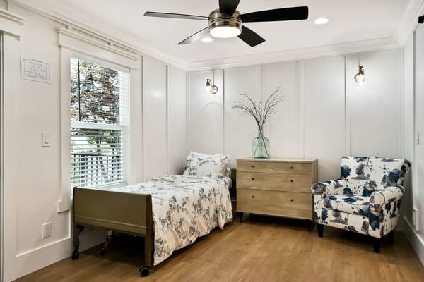 Private resident room with a bed and floral decor