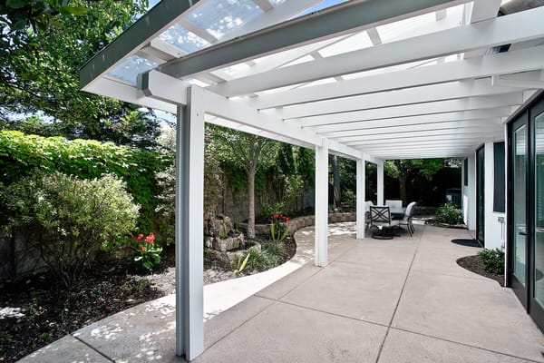 Outdoor patio area with seating and garden