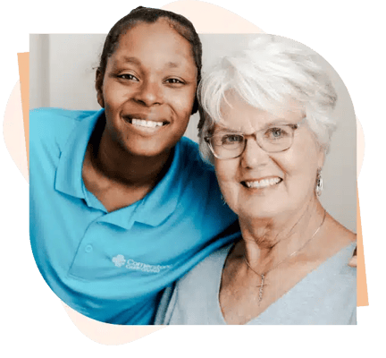 A staff member and a resident smiling together