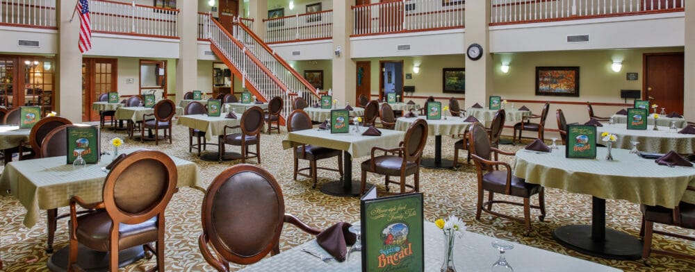 Bright dining area with tables set for residents