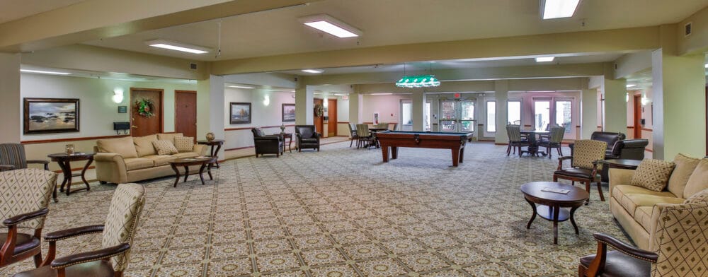 Bright common area with seating and a pool table