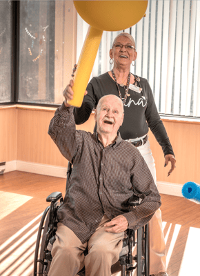 Residents engaging in a group activity in a bright room