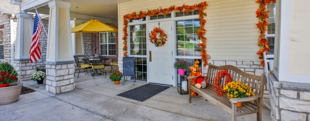 Exterior entrance decorated for fall with flowers