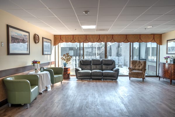 Bright common area with seating and artwork.