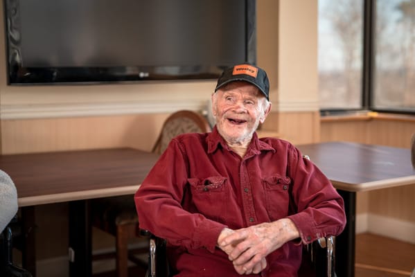 Smiling resident seated in a common area