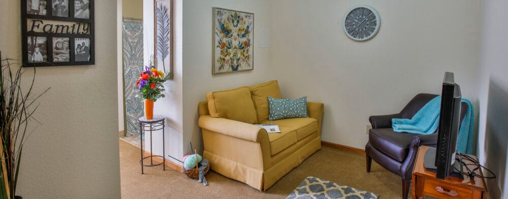Cozy resident room with a sofa and flowers