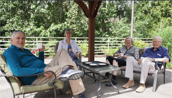 Residents enjoying coffee on a patio