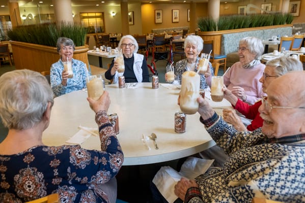 Residents enjoying ice cream floats in the dining room