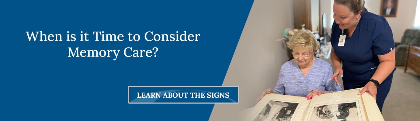 Staff member assisting resident with memory care materials