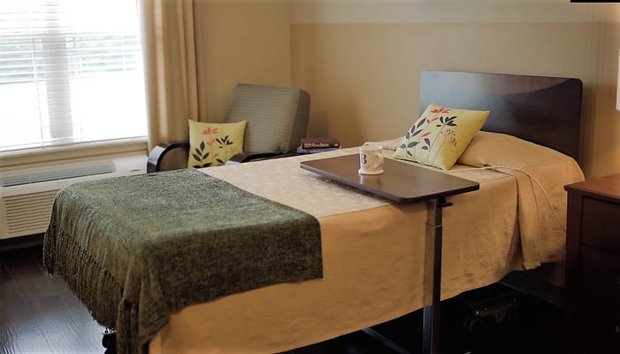 Cozy private resident room with a bed and seating area