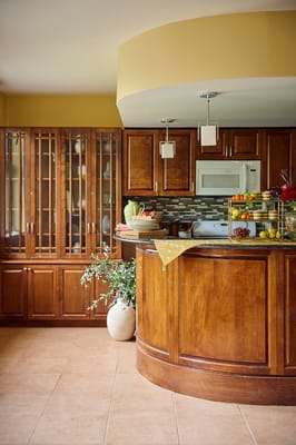 Interior kitchen area with wooden cabinets and fruit display