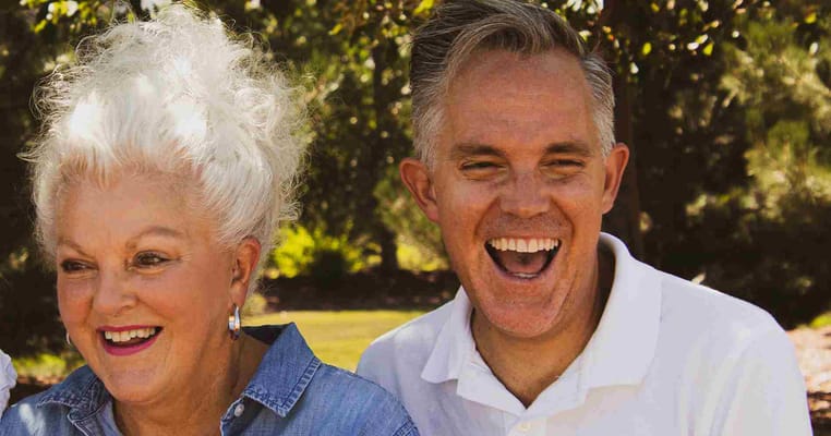 Two happy seniors laughing outdoors