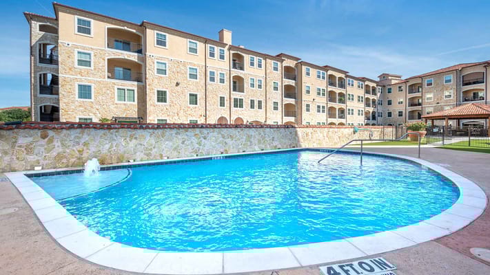 Swimming pool area surrounded by residential buildings