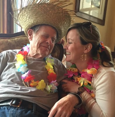 A resident enjoying a festive moment with a staff member