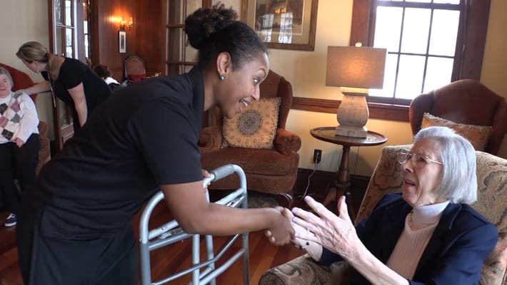 Staff members engaging with residents in a cozy common area