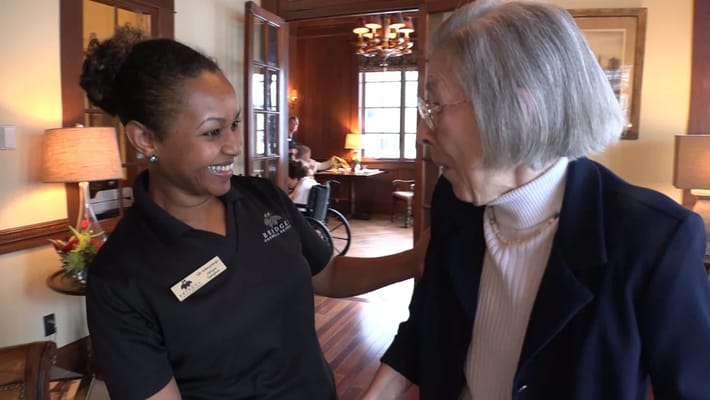 Staff member interacting with a resident inside the facility