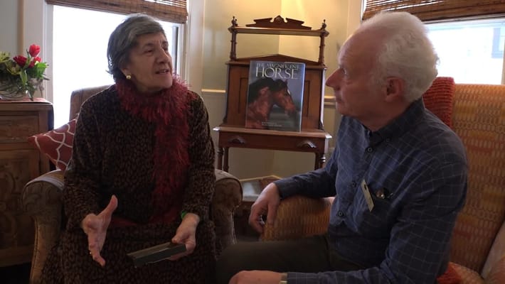 Two residents engaged in conversation in a cozy setting