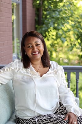 Resident enjoying the outdoor space with greenery in the background
