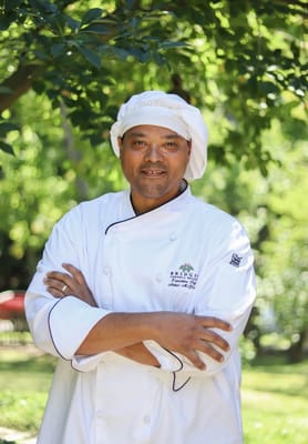 Chef standing outdoors in a serene garden