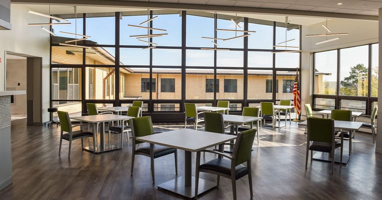 Dining area with large windows and modern furnishings