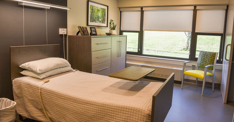 Private resident room with bed and furnishings