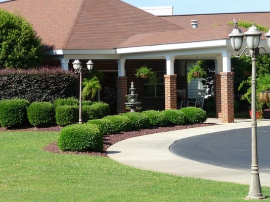 Beautiful landscaped entrance of a senior living facility