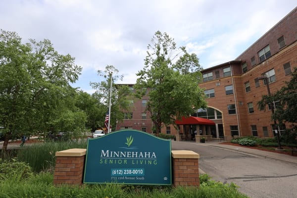Entrance of Minnehaha Senior Living with sign and trees